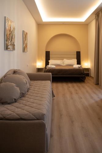 a bedroom with a bed and a couch in it at Palazzo Cappuccini Art Relais in Naples