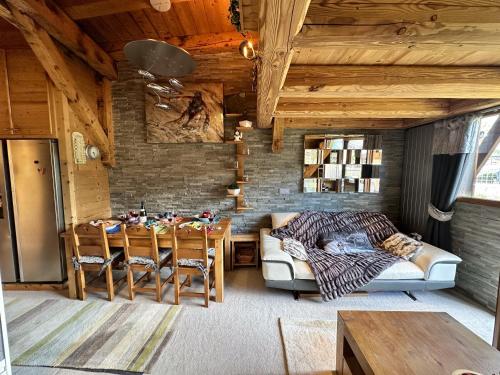 a living room with a couch and a table at Chalet Flocon - luxury ski chalet by Avoriaz Chale in Avoriaz