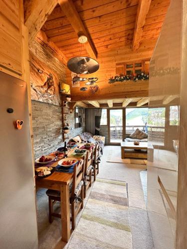 a dining room with a long table in a house at Chalet Flocon - luxury ski chalet by Avoriaz Chale in Avoriaz