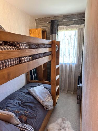 a bedroom with two bunk beds in a room at Chalet Flocon - luxury ski chalet by Avoriaz Chale in Avoriaz