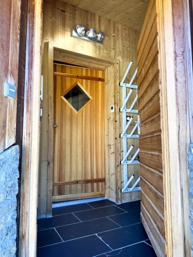 a room with a wooden door and a ladder at Chalet Flocon - luxury ski chalet by Avoriaz Chale in Avoriaz