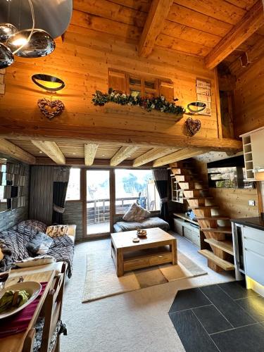 a living room with a staircase in a cabin at Chalet Flocon - luxury ski chalet by Avoriaz Chale in Avoriaz