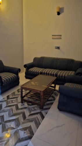 a living room with two couches and a coffee table at Hotel Golden Inn in Karachi