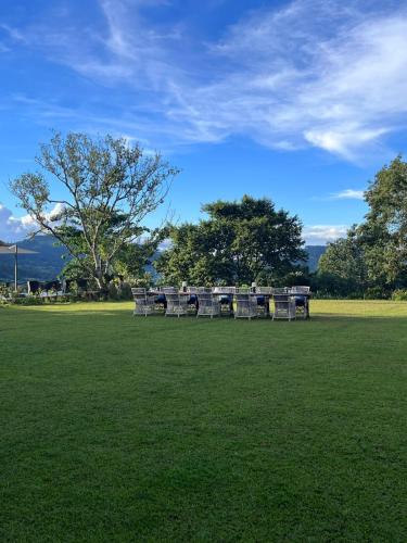a group of picnic tables in a field of grass at Kandy Dendrobium House in Kandy