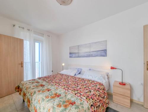 a bedroom with a large bed with a floral bedspread at Belvedere dole in Novigrad Istria