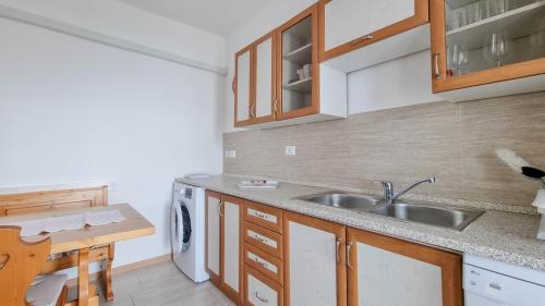 a small kitchen with a sink and a table at Belvedere dole in Novigrad Istria