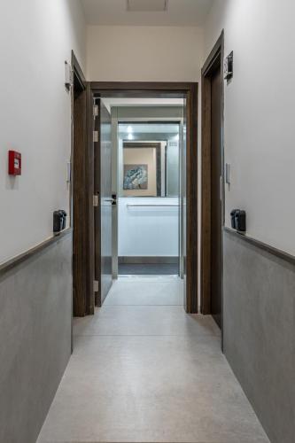 a corridor of a hallway with doors and a hallway at Studio 41 at the vibrant Olo living guesthouse in Paceville