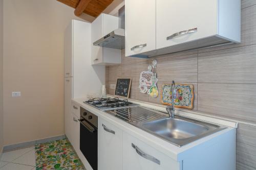 a kitchen with a sink and a stove at Le tre pigne in Floridia