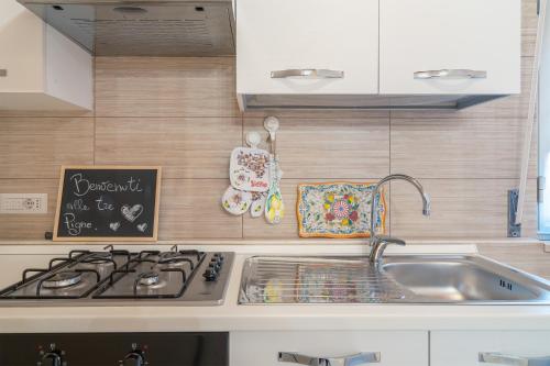a kitchen with a sink and a stove at Le tre pigne in Floridia