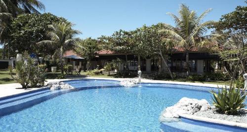 a large swimming pool in front of a resort at Villa Stefan in Pantai Anyer