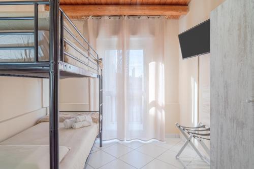 a bedroom with a bunk bed and a window at Le tre pigne in Floridia