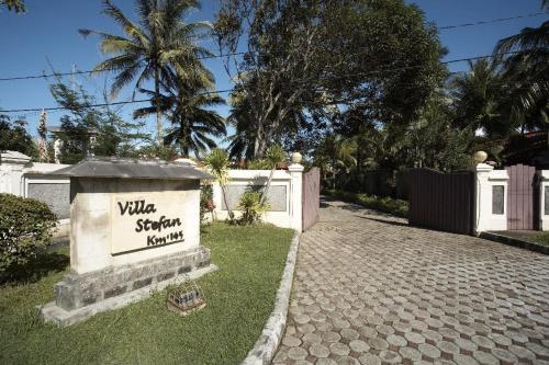a sign for a villa with a fence at Villa Stefan in Pantai Anyer