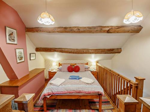 a bedroom with a bed with red pillows on it at 3 Bed in Conwy 50933 in Eglwys-Fâch