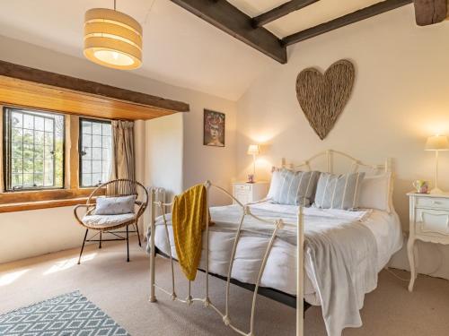 a bedroom with a large bed with a heart on the wall at 4 bed in Priestcliffe 57687 in Millers Dale