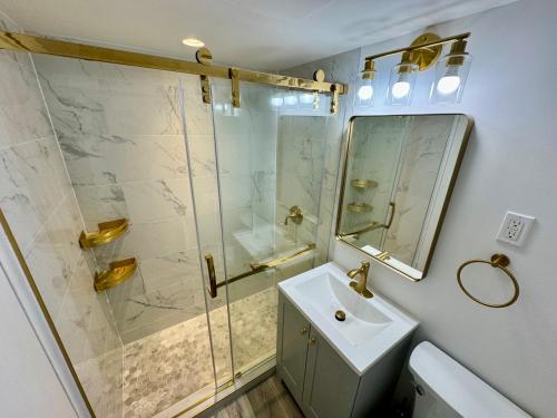 a bathroom with a shower and a sink and a mirror at Directly on the Beach with Pool & Parking in Miami Beach