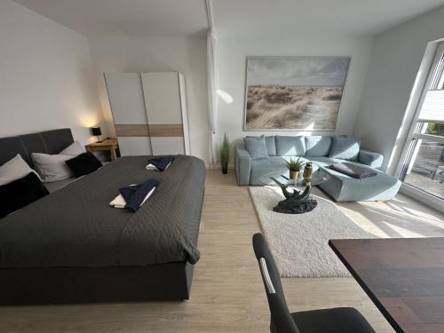 a living room with a couch and a blue couch at Ferienwohnung SEESTERN **** in Rostock
