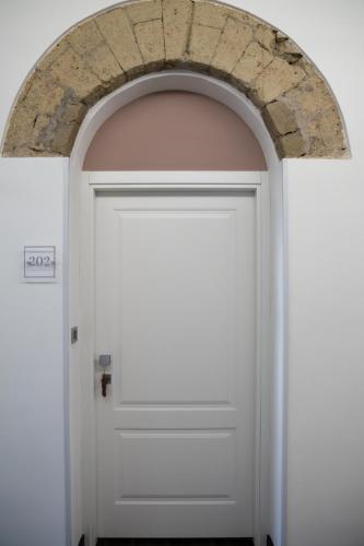 an archway over a white door at Palazzo Cappuccini Art Relais in Naples