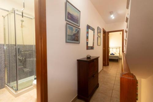 a hallway with a bathroom with a shower and a toilet at Casa Bianca Caleta De Famara in Famara