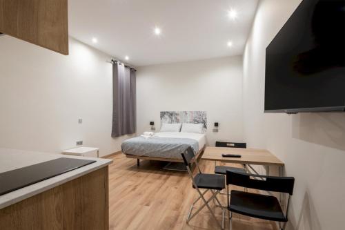 a bedroom with a bed and a desk and a table at 1 bedroom 1 bathroom furnished - Justicia - Modern - MintyStay in Madrid