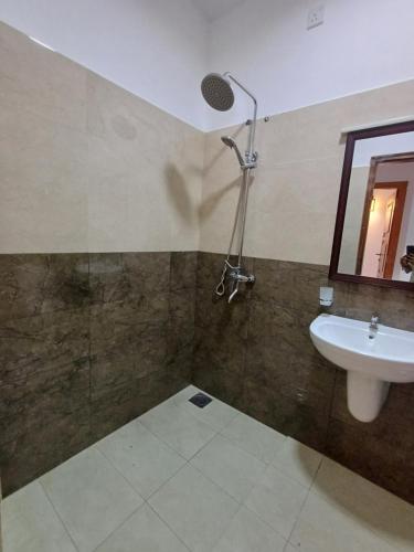 a bathroom with a sink and a shower at 3B in Dehiwala