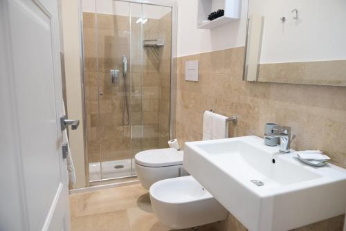 a bathroom with a sink and a toilet and a shower at ZIBIBBO SUITES & ROOMS - Aparthotel in Centro Storico a Trapani in Trapani