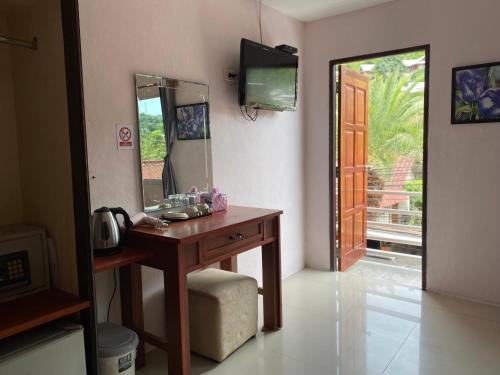 a bathroom with a wooden vanity and a mirror at Sabai House in Phi Phi Islands