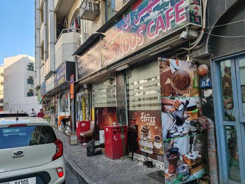 a car parked in front of a store on a street at Qamar home rental Deira in Dubai