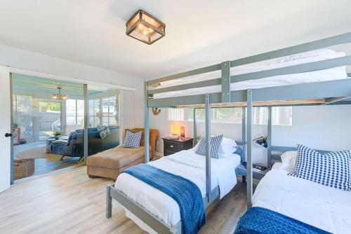 a bedroom with two bunk beds and a living room at Largo Beach House in Largo