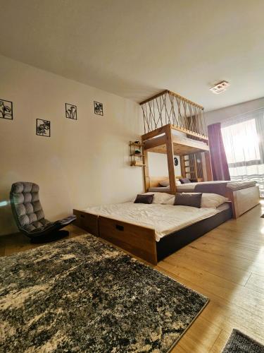 a bedroom with a bunk bed and a chair at H11 - Evergreen Tale in Bystrá