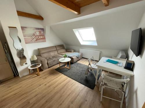 a living room with a couch and a table at Apartment SCHLEUSENTOR - Ferienwohnung Maisonette in Rostock