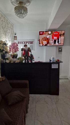 a store with a counter with a pumpkin on the wall at Pensiunea Toma in Ploieşti