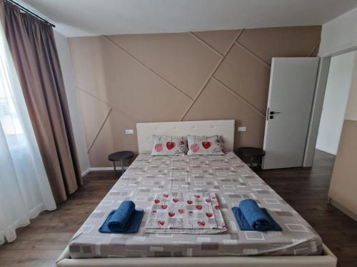 a bedroom with a bed with red roses on it at Blue apartment nearby Amethyst & Vivo Mall in Floreşti