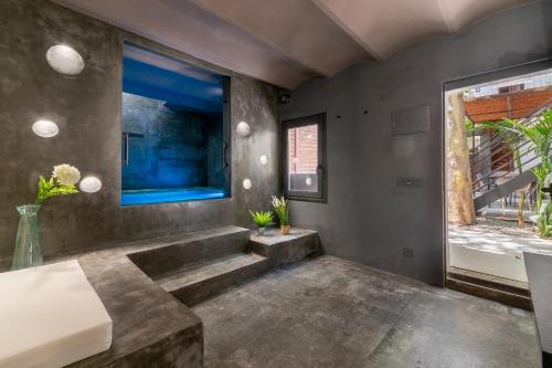 a bedroom with a concrete floor and a large window at Tendency Apartments 9 in Barcelona