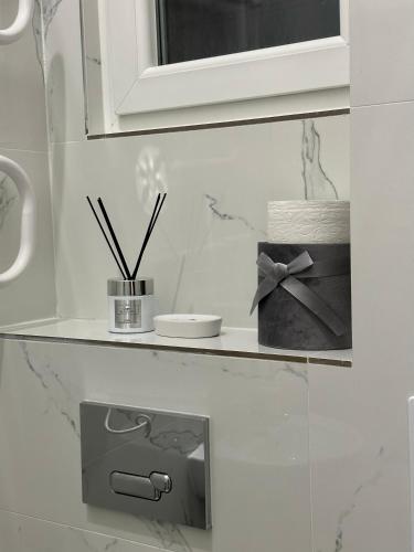 a shelf in a bathroom with a roll of toilet paper at Dolce Vita House in Budapest