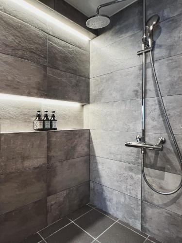a bathroom with a shower with a glass door at Exquisite business hotel Bella in Tokyo