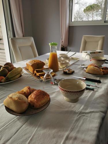 a table with bread and other food on it at Chambre de Bajolle in Fourcès