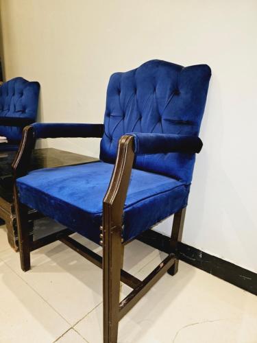 een blauwe stoel naast een tafel bij Rose Palace Hotel Karachi in Karachi