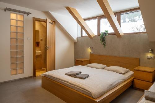 a bedroom with a large bed with white sheets at Apartmány pro rodiny s dětmi - Permoník in Dolní Malá Úpa