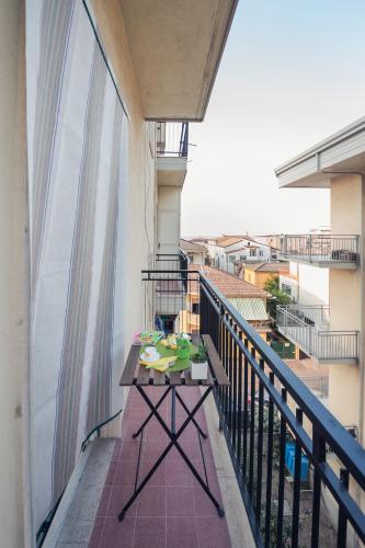 a balcony with a table and a view of a city at Il Quadrato Bed and Breakfast in Marina di Schiavonea