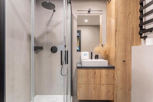 y baño con ducha y lavamanos. en Mountain Tree Apartament C27 Apart Invest, en Szklarska Poręba
