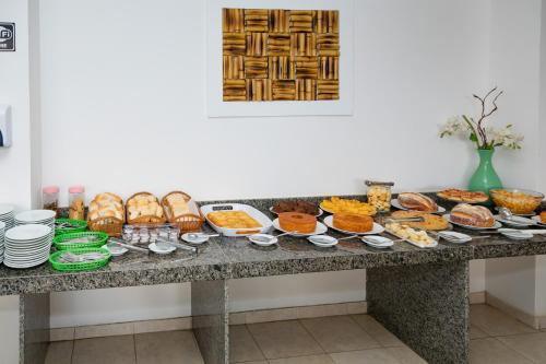 a table filled with lots of different types of food at Moriah Maceió Beach Hotel in Maceió