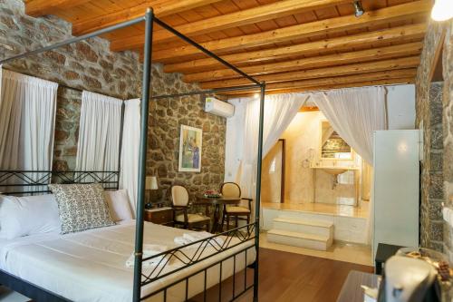 a bedroom with a bed and a dining room at Nereids Guesthouse in Hydra