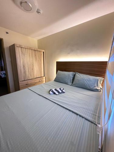 a bed with a pair of towels sitting on it at 8 Spatial - ForeverMC Condotel 2BR 5615 in Davao City