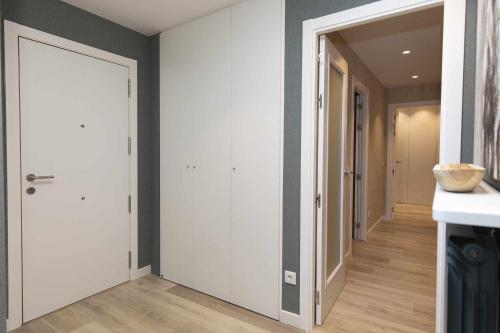 a hallway with a white door in a room at El Ciervo de Santa María by BeValle in Panticosa