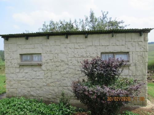 a stone building with a grass roof at Elandskloof Trout Farm in Dullstroom