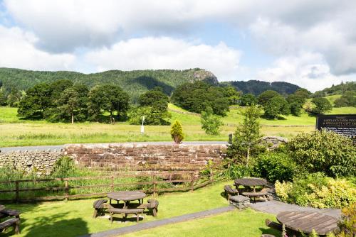 a group of picnic tables in a field at The King's Head in Thirlmere