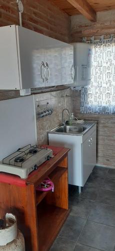 a kitchen with a stove top and a sink at La Posada De Vito in Córdoba