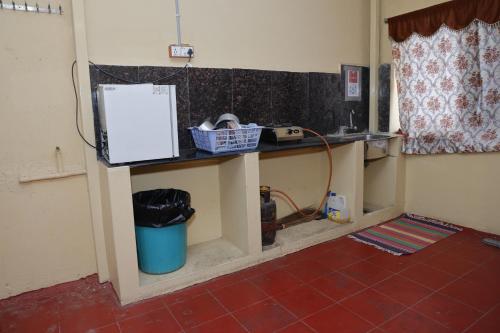 a kitchen with a counter and a trash can at 3 BHK-Air Coolers for 4 to 10 Guests for Families in Hyderabad