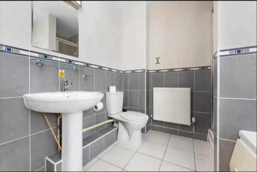 a bathroom with a toilet and a sink at Ensuite Room in Cardiff City Centre in Cardiff