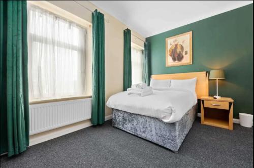 a hotel room with a bed and a window at Ensuite Room in Cardiff City Centre in Cardiff